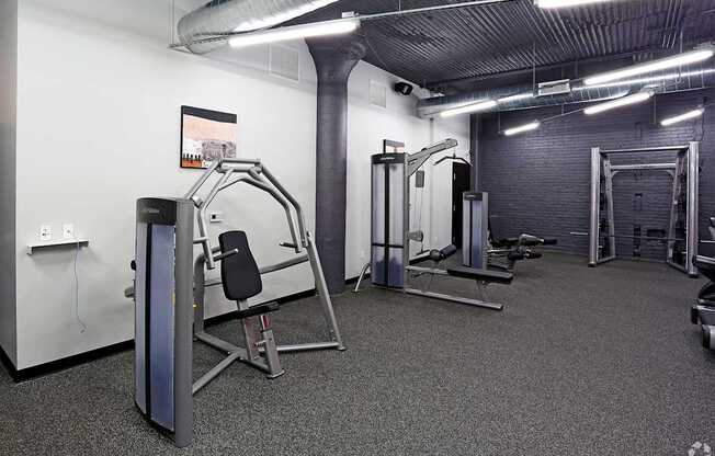 A gym with a variety of equipment including a leg press machine.