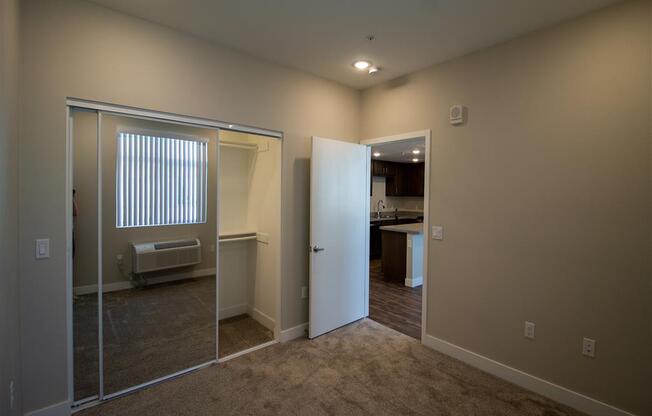 a bedroom with a large mirror and a closet at Loma Villas Apartments, San Bernardino, 92408