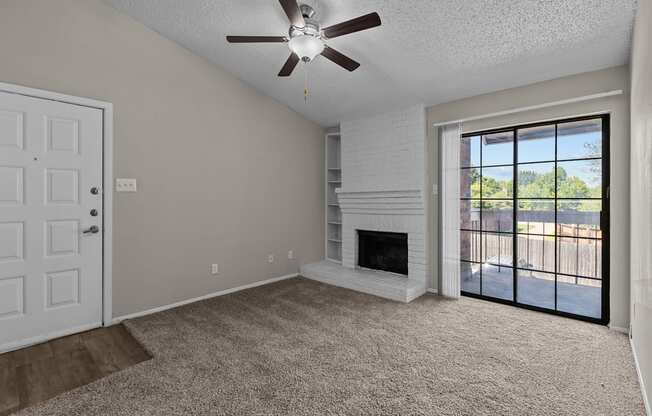 A room with a fireplace and a ceiling fan.