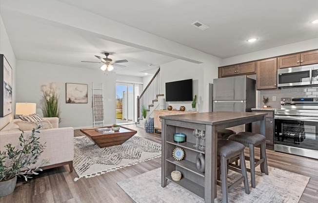 an open living room with a kitchen and a living room