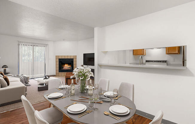 a dining area with a table and chairs and a fireplace in the background