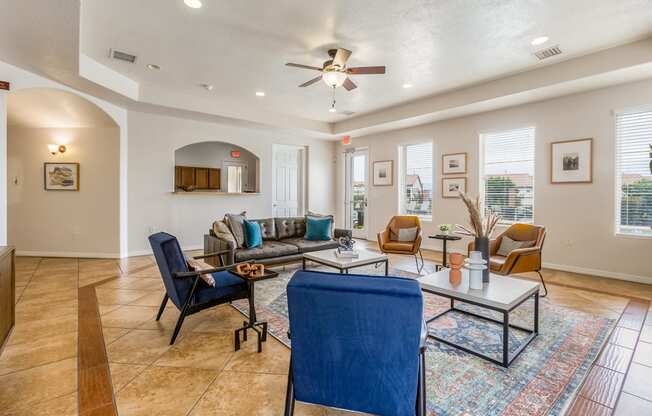 a living room with furniture and a ceiling fan