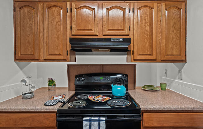 a kitchen with wooden cabinets and a black stove
