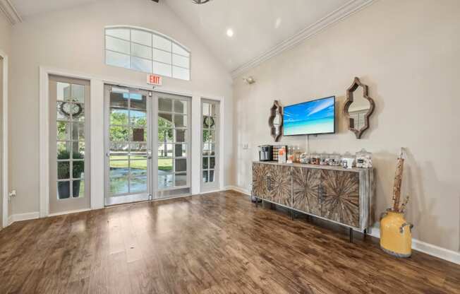 the living room of a house with a bar and a door to a patio