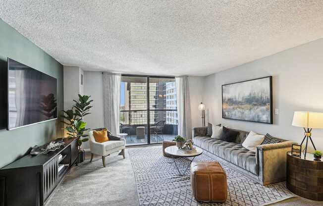 a living room with a couch and a tv and a balcony