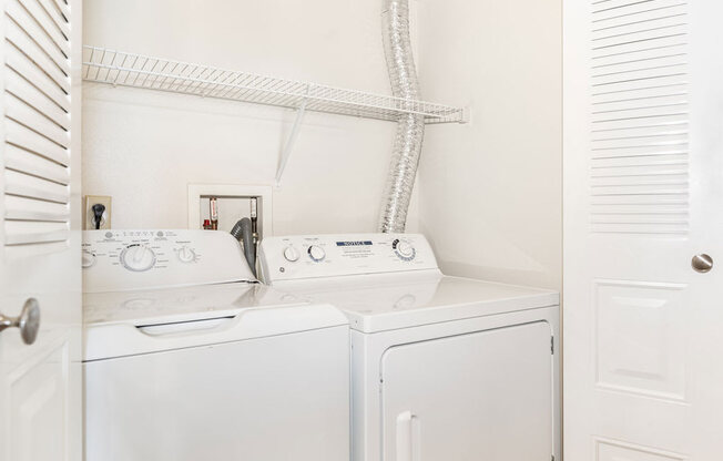 a washer and dryer are in the laundry room