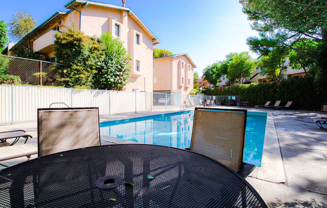 View of seating area by the pool at Olive View Gardens.