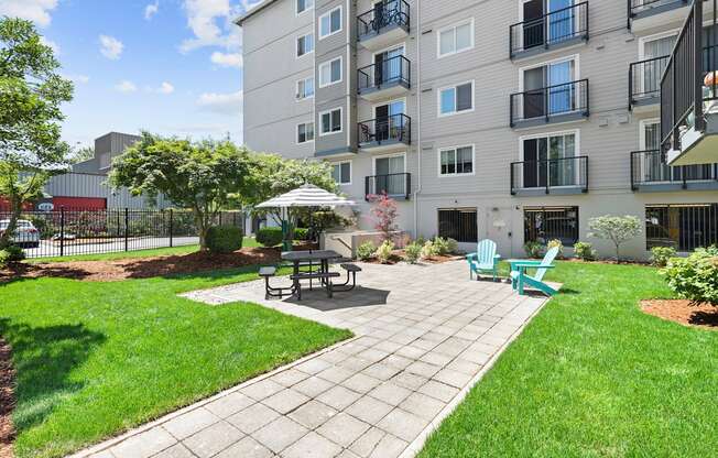 Resident community patio with outdoor lounge seating at King Arthurs Court, Washington, 98125