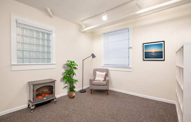 a living room with a fireplace and a chair