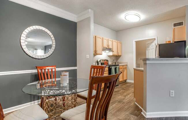 Model kitchen with dining room at Peachtree Landing Oakley Industrial Blvd apartments.