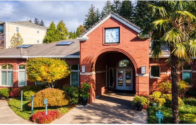 A red brick building with a clock on the front at Wilsonville Summit Apartments, Wilsonville  97070