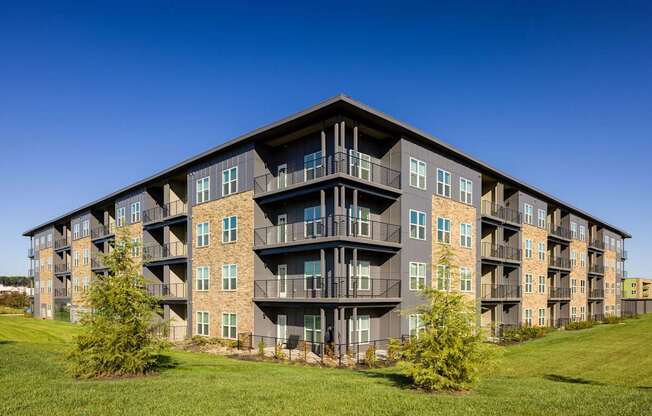 A large apartment building with balconies and multiple windows.