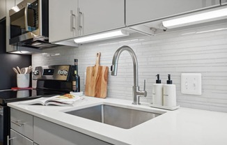 a kitchen with a sink and a microwave at Sinclaire on Seminary, Alexandria, VA 22311