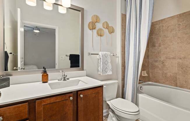 A bathroom with a sink, toilet, and bathtub.