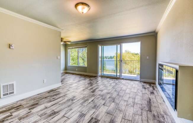 an empty living room with sliding glass doors to a balcony