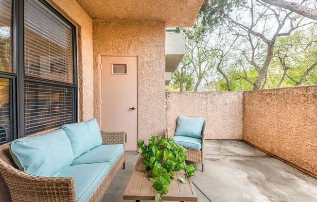 a patio with two chairs and a table