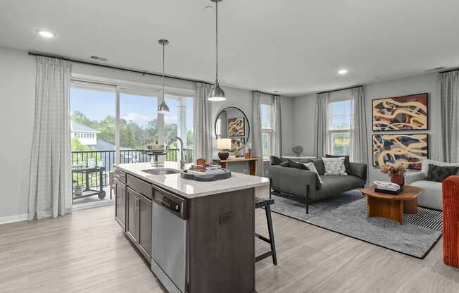 A modern kitchen with a large island and a view of the backyard.