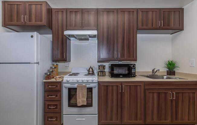 a kitchen with stainless steel appliances and wooden cabinets