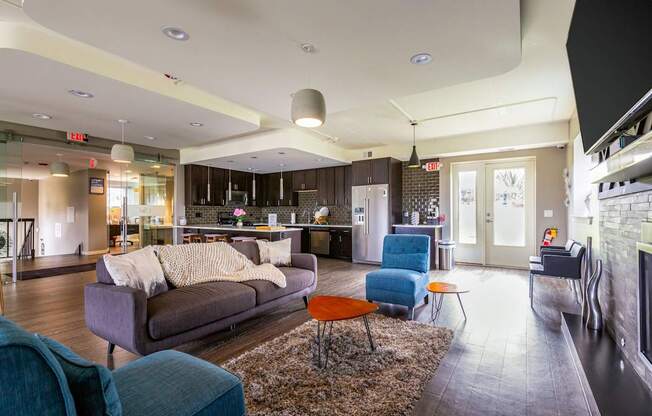 A living room with a grey couch and a blue chair.