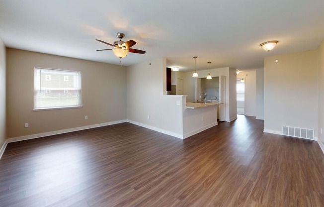 End living room with a ceiling fan and hard surface flooring