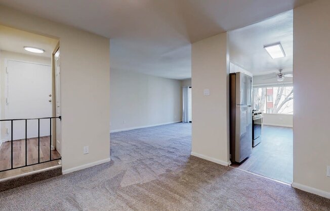 a renovated living room with a kitchen and a staircase