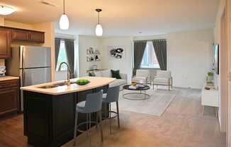 a kitchen and living room with an island in the middle of it