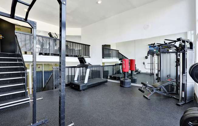 A black and white photo of a gym with a variety of equipment.