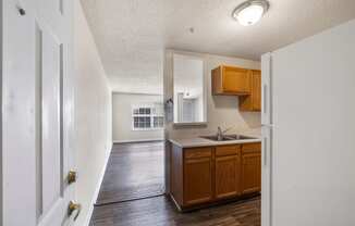 an empty kitchen with wooden cabinets and a sink