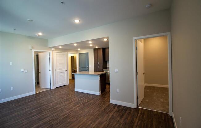 empty living room with a kitchen in the background at Loma Villas Apartments, San Bernardino, California