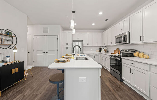 a large white kitchen with a white counter top