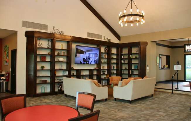 a living room with couches and chairs and a tv