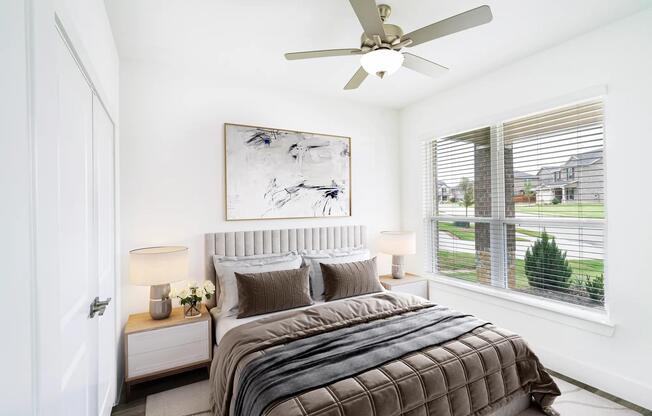 One of four beautifully designed bedrooms at Amavi Celina, this airy space blends natural light with cozy sophistication and neighborhood views.