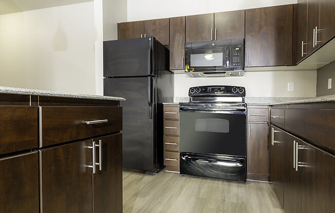 a kitchen with a black stove from The Lotus Apartments in Downtown Salt Lake City, Utah