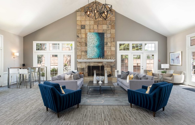 a living room with couches and chairs and a fireplace