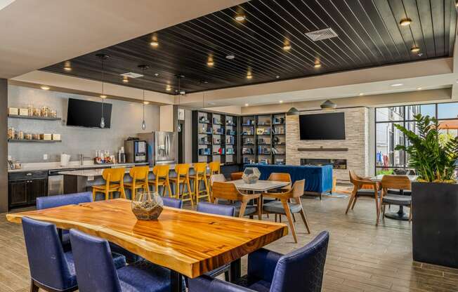 a dining room with tables and chairs and a bar and television