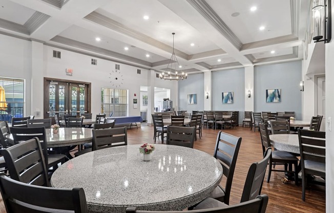 A large event room with round tables and chairs at Encore at Buckingham Apartments in Richardson, TX