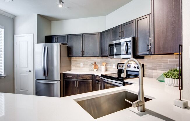 a kitchen with a sink and a refrigerator