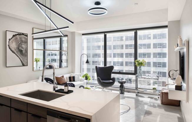 a kitchen and living room with a large window at 220 Meridian, Indianapolis, IN 46204