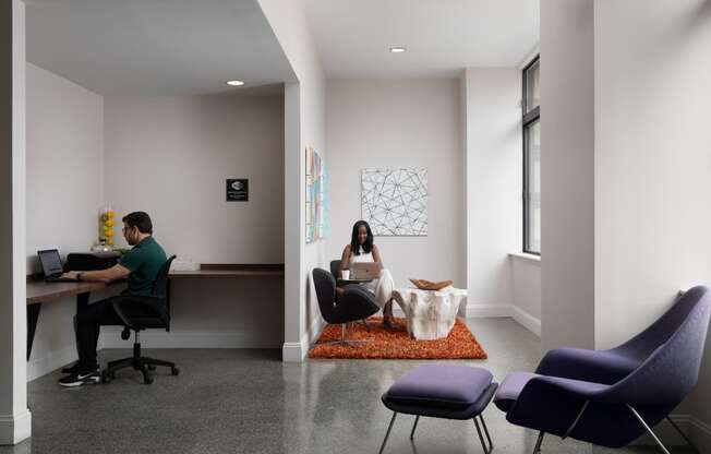 a man and a woman sitting at a desk in an office