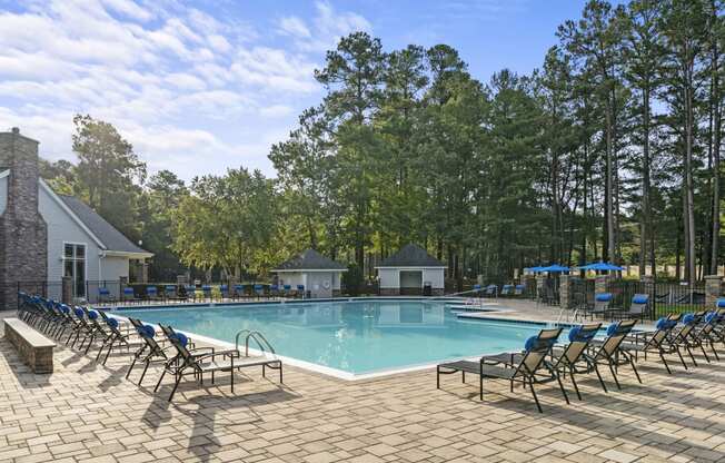 our resort style swimming pool is surrounded by lounge chairs at Trails at Short Pump Apartments, Richmond, Virginia