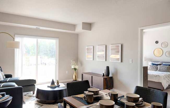A modern living room with a dining table set for four.