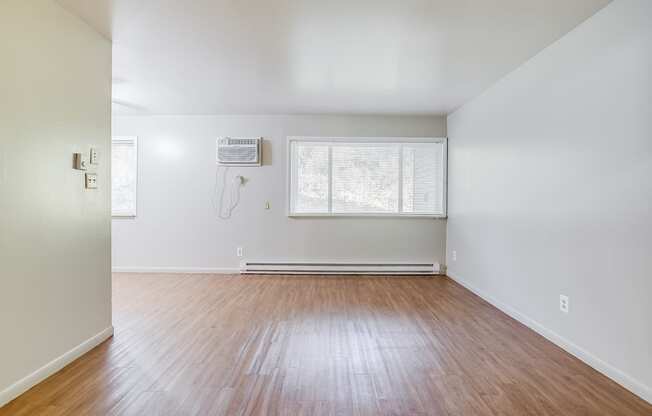 a living with hardwood floors and white walls