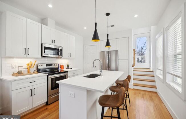 Welcome to 1181 Neal Street NE, a stunning 3-level townhome offering a private rooftop deck with breathtaking skyline views and off-street parking.