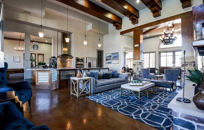 a living room with couches and chairs and a kitchen