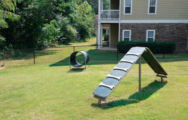 a seesaw in a yard with a house in the background at Ashby at Ross Bridge, Hoover