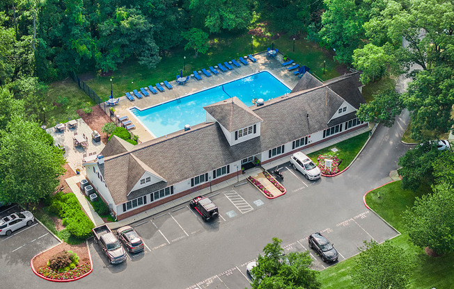 A large building with a pool in front of it.
