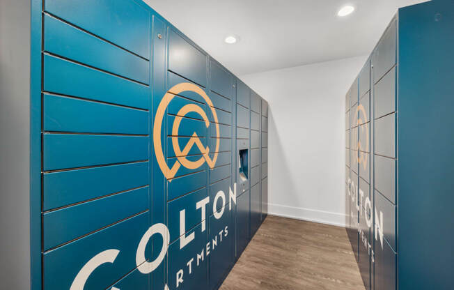 a hallway with blue lockers and a logo on the wall