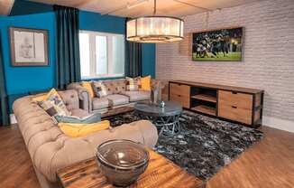 A living room with a grey sofa and a wooden coffee table