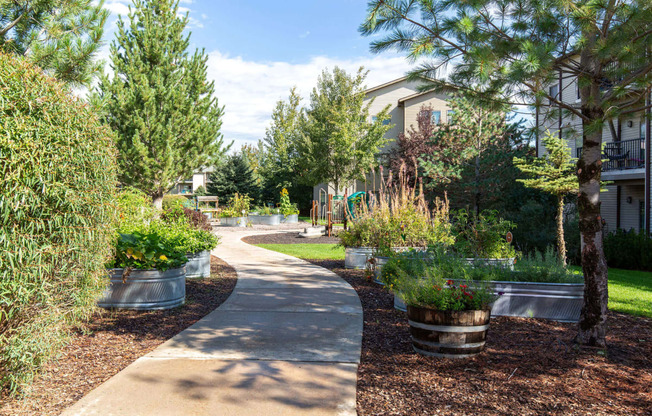 a path through the community with trees and plants on either side at Mullan Reserve Apartments, Missoula, MT 59808