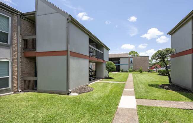 A sunny day at the apartment complex with a clear blue sky.